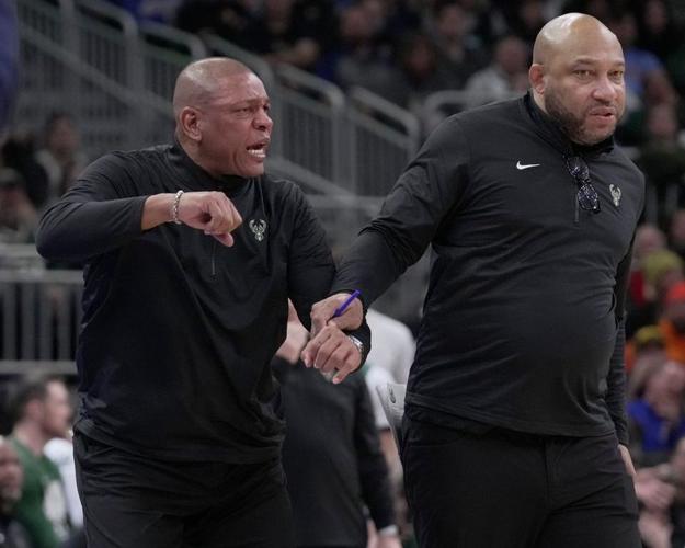 Milwaukee Bucks coach Doc Rivers, left, is held back by assistant coach Darvin Ham after being given a technical foul.