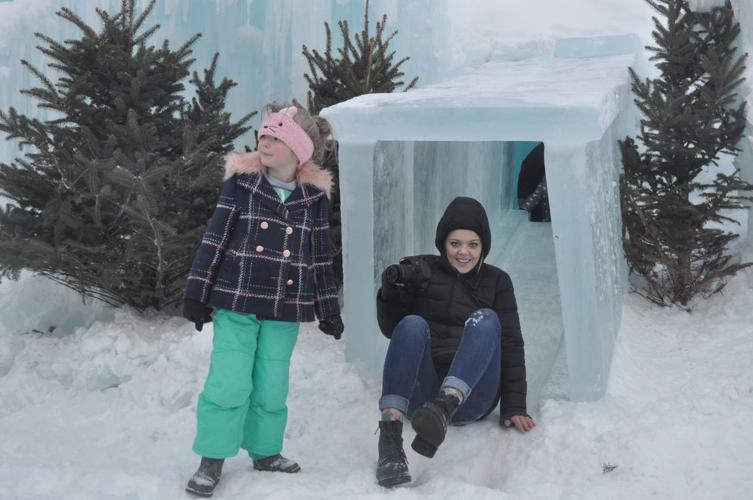 Chelsea Nebersell of Crystal Lake comes down a slide at the ice castle structure