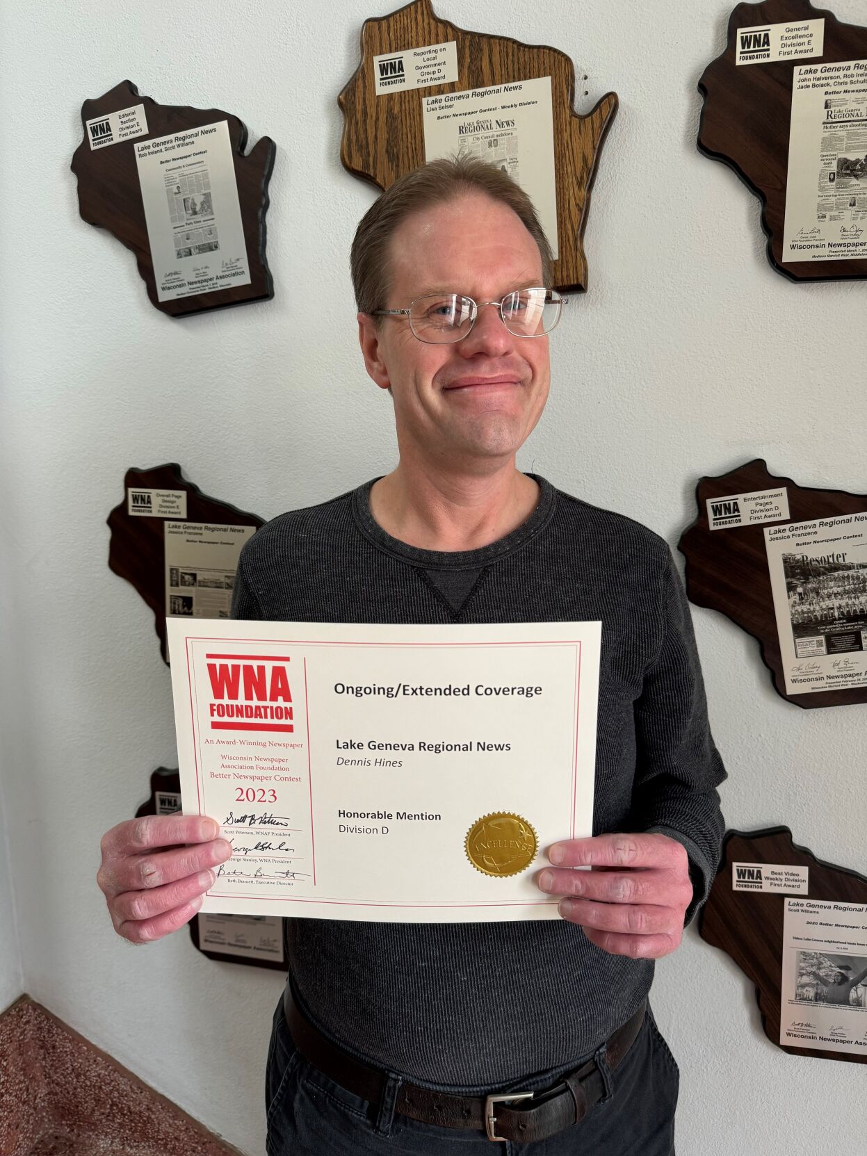 Lake Geneva Regional News Reporter Dennis Hines with Better Newspaper Contest award