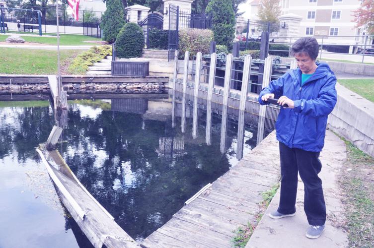 Harbormaster Linda Frame records a damaged pier during her walk through of the lakefront area