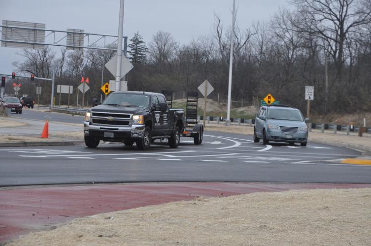 Two vehicles travel on the recently completed roundabouts on Highway 120