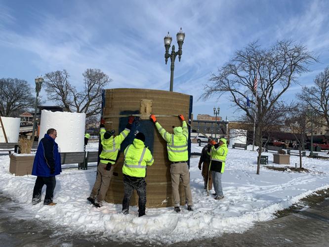 Crews prepare another large cylinder to create a snow block