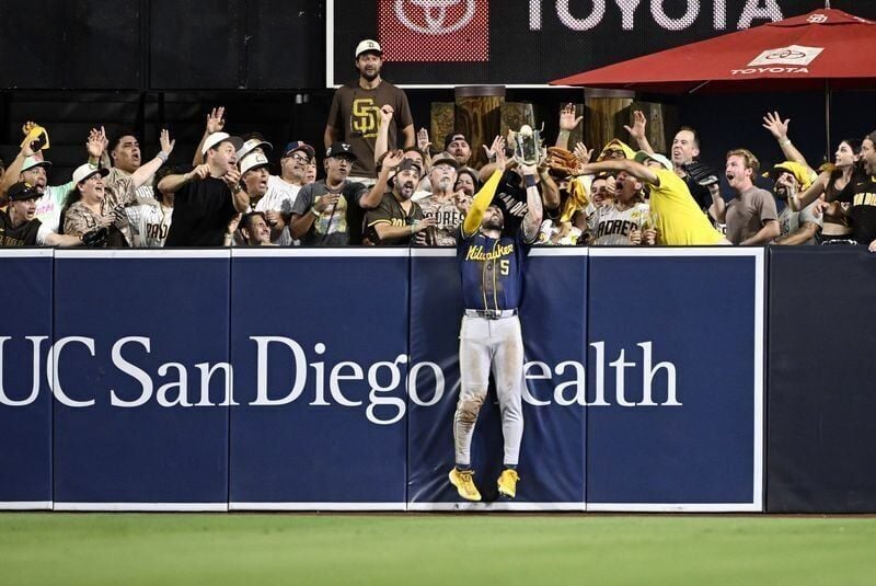 Brewers center fielder Garrett Mitchell takes a home run away from Padres third baseman Manny Machado during the eighth inning on Wednesday, Oct. 7 at Petco Park in San Diego.