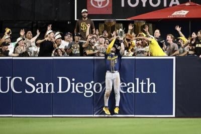 Brewers center fielder Garrett Mitchell takes a home run away from Padres third baseman Manny Machado during the eighth inning on Wednesday, Oct. 7 at Petco Park in San Diego.