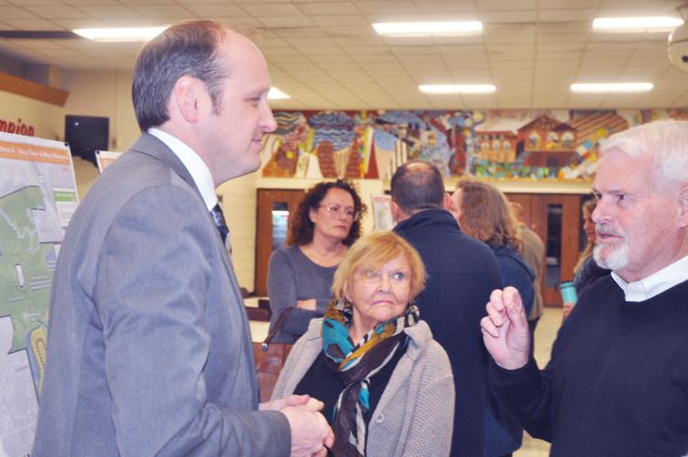 Brian Munson, Vandewalle & Associates, talks to Jackie Getzen and Alderman John Halverson