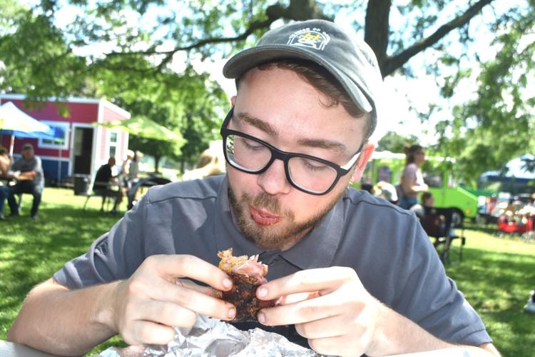 Austin Pelphrey eats ribs during Greater Racine BBQ Invitational contest in Caledonia