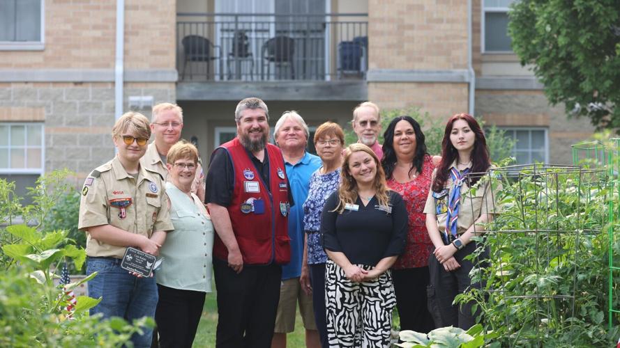 Group photo in front of garden beds