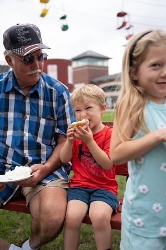 Nolan Ebal, 4, and Juniper Ebal, 6, try cream puffs for the first time with their grandparents Tom Wiznerowicz and Mary Ann Wiznerowicz of Richmond, Ill., at the Wisconsin State Fair Park on opening day Aug. 6, 2026 in West Allis, Wisconsin.