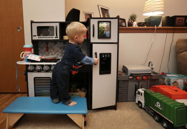 Theo with play kitchen