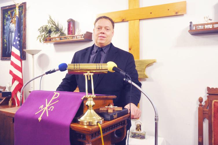 Ken Dillingham stands at the pulpit of the Wayman Chapel African Methodist Episcopal Church