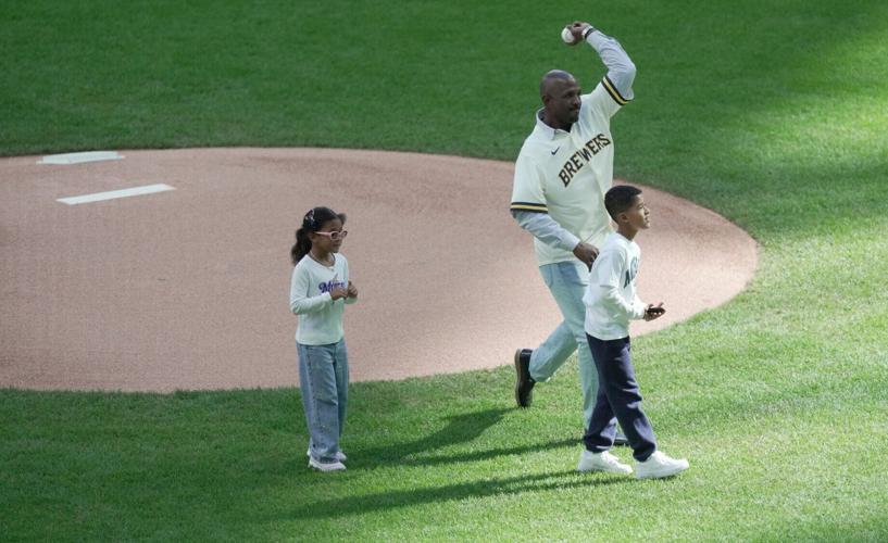 Former Milwaukee Brewers Nyjer Morgan throws out a ceremonial first pitch before their National League Division Series game
