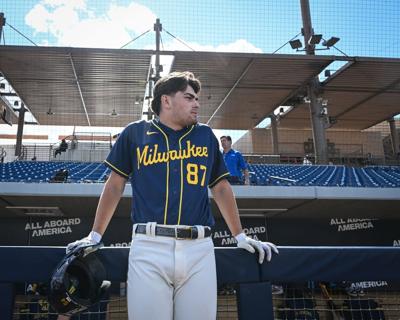 Milwaukee Brewers infield prospect Brady Ebel leans along the dugout rail during spring training workouts Tuesday, February 17, 2026, at American Family Fields of Phoenix in Phoenix, Arizona.