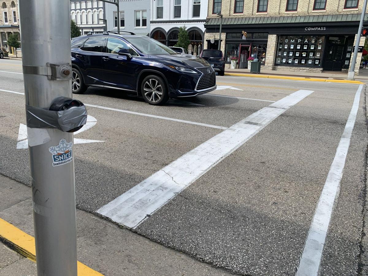 Grey tape has been placed over the crosswalk buttons at the lighted intersections of Main Street to indicate that they have been disabled