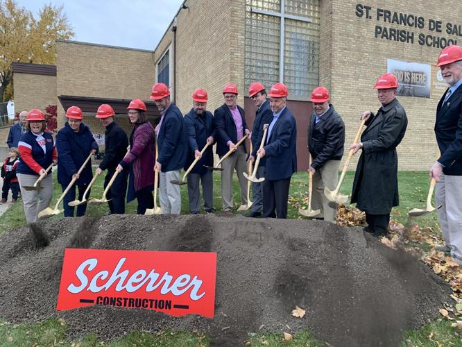 St. Francis de Sales school and church officials shovel some dirt to kick off the school's expansion project