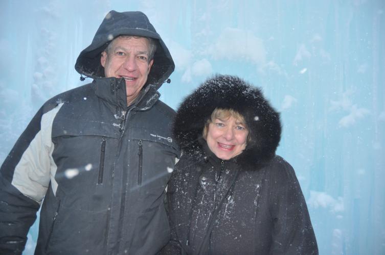 Jeff and Lenore Berman of Lindenhurst, Illinois wait in line to go down one of the the slides in the ice caslte