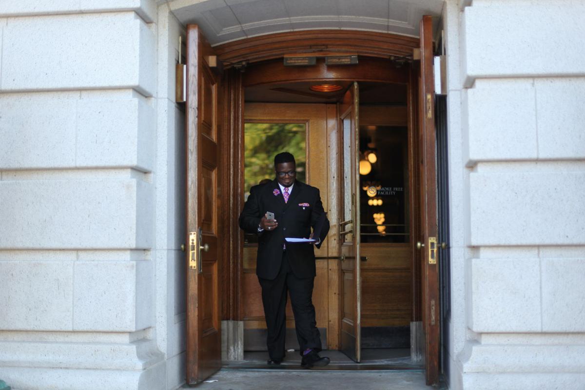 Vasser walking out of building