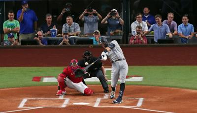 In this photo from October 4, 2022, Aaron Judge of the New York Yankees hits his 62nd home run of the season against the Texas Rangers during the first inning in game two of a doubleheader at Globe Life Field in Arlington, Texas.