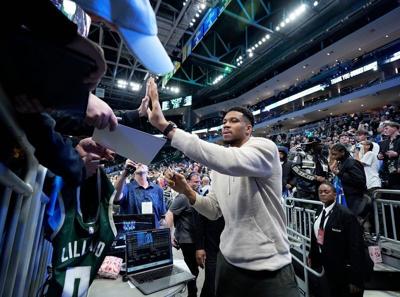 Milwaukee Bucks forward Giannis Antetokounmpo signs autographs after a game on April 10 at Fiserv Forum.