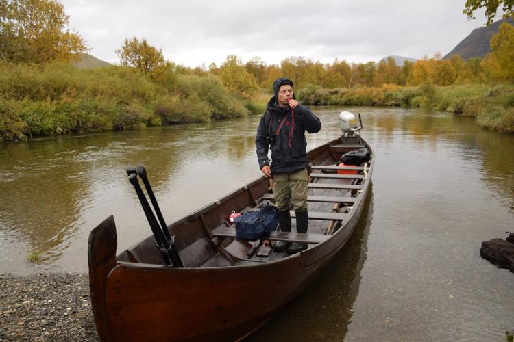 Mikael Vinka stands in his boat, which is the main way to access the remote Sami Ecolodge, which welcomes guests 12 times a year. Visitors can take a snowmobile in the winter.
