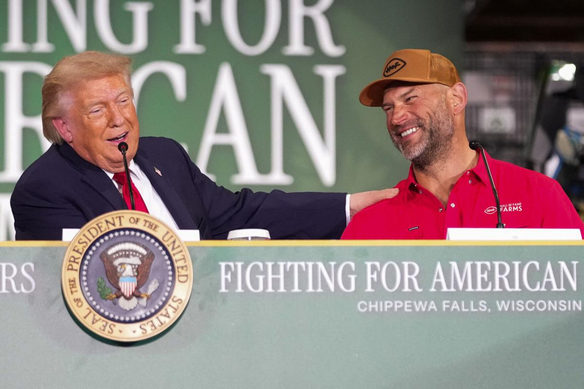 U.S. President Donald Trump grabs Joe Thomas' shoulder as he speaks during an event at Custer Farms in Chippewa Falls, Wisconsin, U.S., June, 5, 2026. REUTERS/Nathan Howard