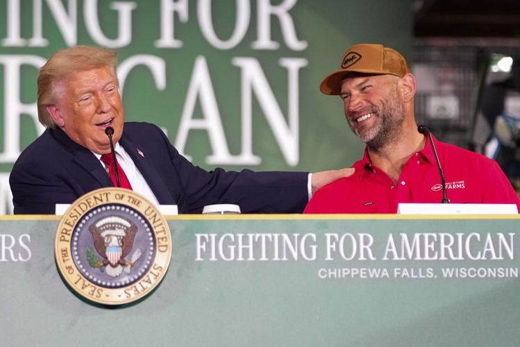 U.S. President Donald Trump grabs Joe Thomas' shoulder as he speaks during an event at Custer Farms in Chippewa Falls, Wisconsin, U.S., June, 5, 2026. REUTERS/Nathan Howard