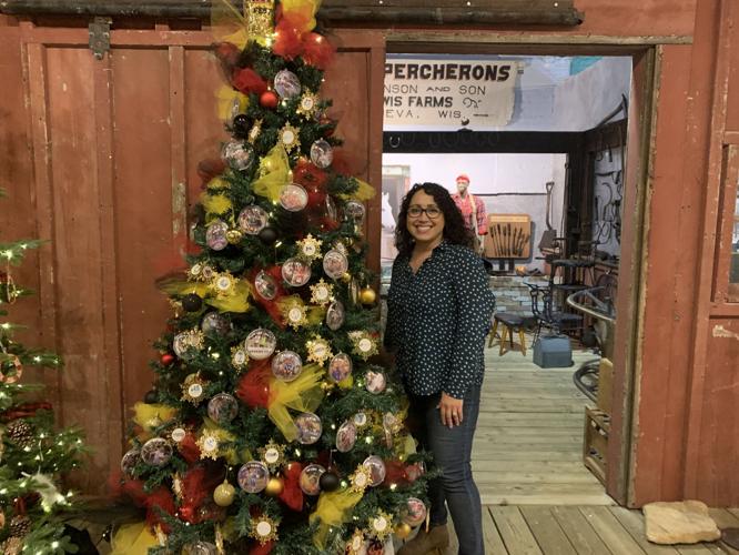 Mindy Amodeo of United Way of Walworth County stands next to her decorated tree