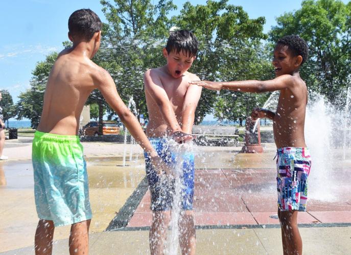 Three boys have fun cooling off in Racine splash pad