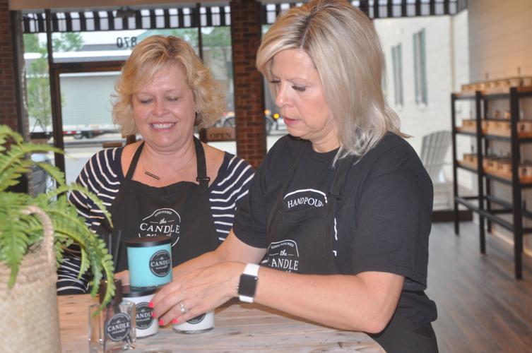 Leigh Ann Myers, left, and Elizabeth Doyle arrange some scents on a table