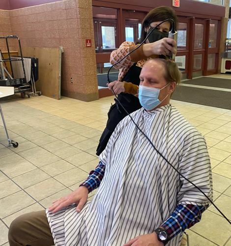 Gina York of Straight to Curly Salon in Genoa City shaves Badger High School Assistant Principal Michael Giovingo's hair