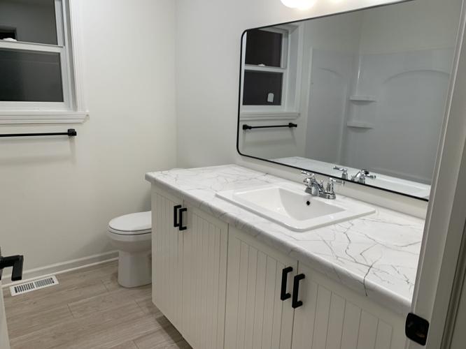 Besides four bedrooms, the house also features two bathrooms, full kitchen and a backyard deck