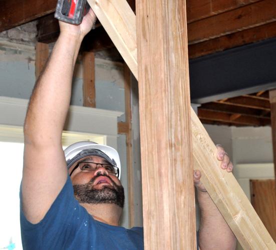 James Clendening, Nikao Group employee, drills together two boards