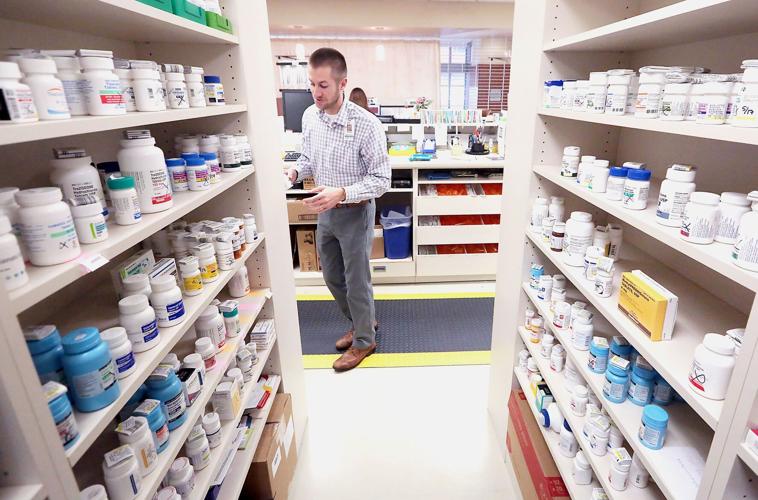 Bognar between rows of drugs