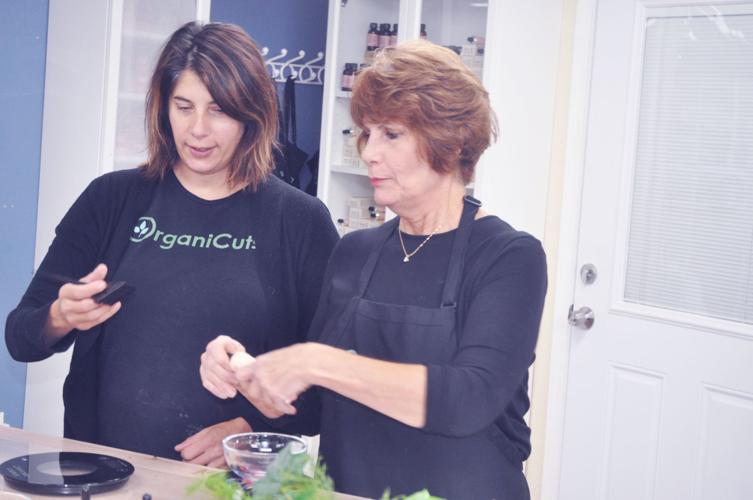 Elizabeth Krause, left, and her mother, Lea Boukidis, mix some haircare products at Krause's salon