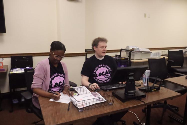 Michelle Cook and Steven Madsen count ballots