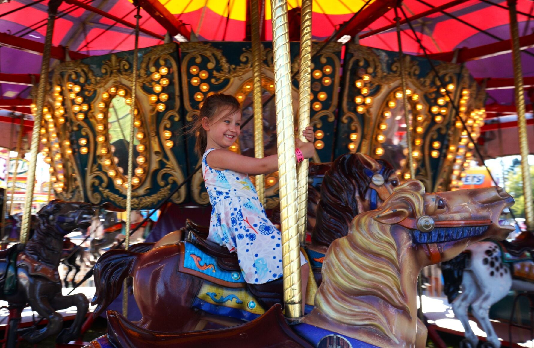 Ava Sarnowski rides the merry-go-round at the 2023 Walworth County Fair