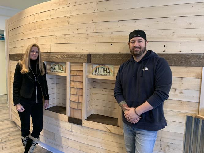 Karen Schutz and Joshua Bernicchi stand next to renovated space at Wicked Poke Hut