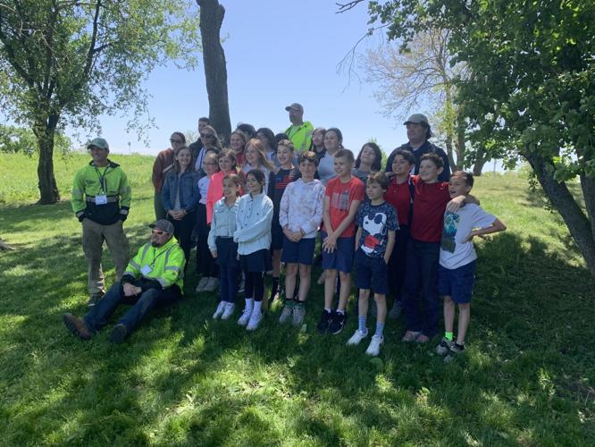 St. Francis de Sales students pose for a photo with some of the mentors who assisted them with the storybook trail project