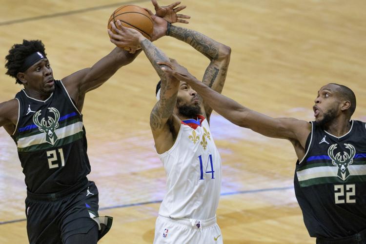 Jrue Holiday, Khris Middleton, AP photo