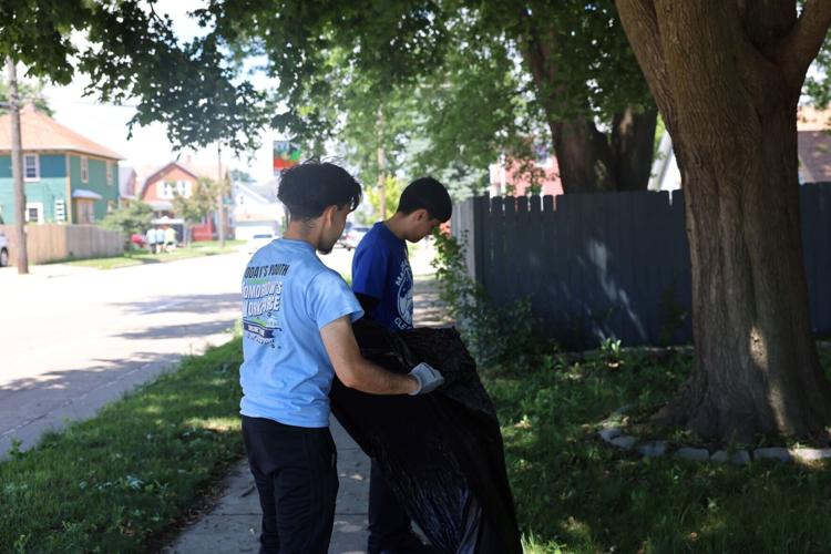 Diego Bustillos and Jose Olivo clean up sidewalk