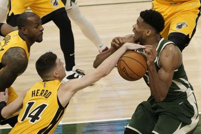 Tyler Herro strips Giannis Antetokounmpo, AP photo