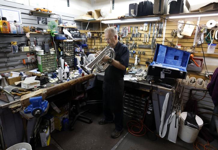 Ward-Brodt technician Jim Huwe tests a marching baritone