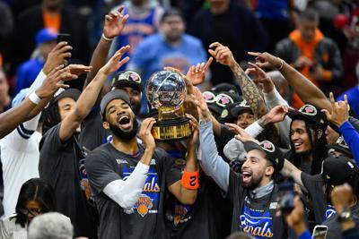 Karl-Anthony Towns lifts the Eastern Conference finals trophy with teammates.