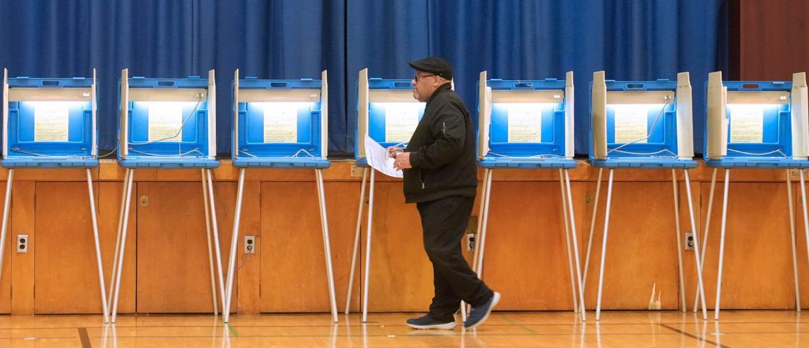 Michael Simmons, 65, carries his ballot after voting at Ninety-Fifth Street School at 3707 N. 94th St. in Milwaukee, Wisconsin (copy)