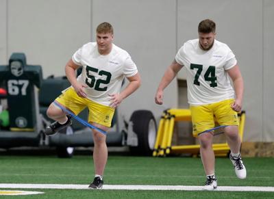 Green Bay Packers Jager Burton, left, and Dylan Barrett stretch during rookie minicamp Friday at the Don Hutson Center in Green Bay.