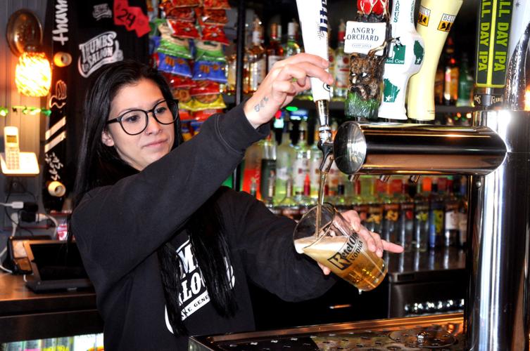 Kirsten Janikowski, Thumbs Up Saloon employee, pours a drink for a customer during a recent shift