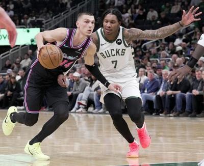Miami Heat guard Tyler Herro drives past Milwaukee Bucks guard Kevin Porter Jr.