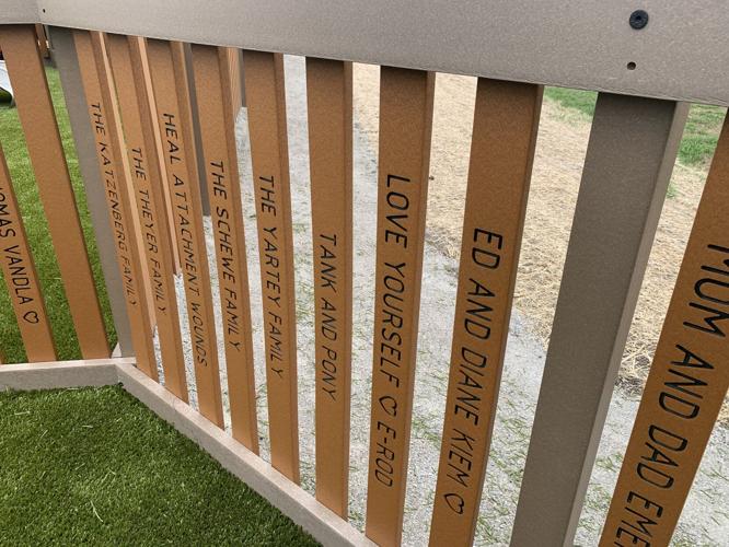 Wooden planks surrounding Never Say Never Playland feature positive messages