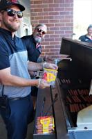 Tyler and Blake Daniels grill Oscar Mayer wieners during the Wienermobile's Aug. 18 visit to Daniels Foods, Walworth