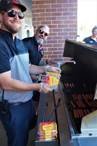 Tyler and Blake Daniels grill Oscar Mayer wieners during the Wienermobile's Aug. 18 visit to Daniels Foods, Walworth