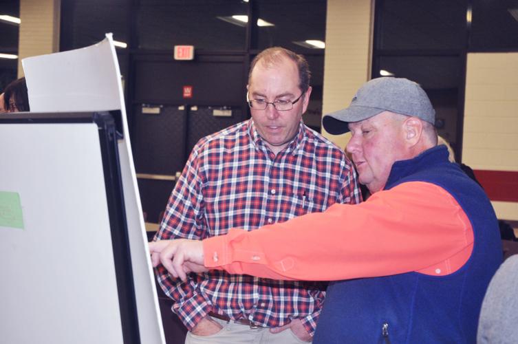 Tom Reed, left, and Sean Payne look over a map regarding a potential option for the Hillmoor